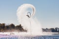 Hydroflight sportsman turning somersault on flyboardon blue sky background at South Russian Aquabike Championship