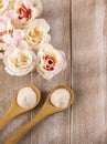 Hydrolyzed collagen powder with flowers on wooden background