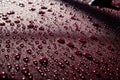 Hydrophobic water effect on red car paint after rain.
