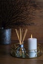 hygge and aromatherapy concept - candles and aroma diffuser on table at home