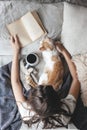 Hygge concept with cat, book and coffee in the bed Royalty Free Stock Photo