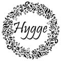 Hygge sign symbolizing Danish Life style surrounded by black and white flower elements in the shape of a circle