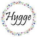 Hygge sign symbolizing Danish Life style surrounded by colorful spring inspired circle surrounded by flowers, leaves, butterflies