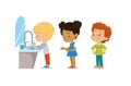 Hygiene. Children are washing their hands. Perspective of children standing at the wash basin. School girls and boys Royalty Free Stock Photo