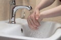 Hygiene. Cleaning Hands. Washing hands with soap. Woman`s hand with white soap and foam. Protect yourself from coronavirus COVID- Royalty Free Stock Photo
