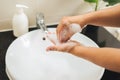 Hygiene concept. Man washes his hands in the bathroom with soap under running water Royalty Free Stock Photo