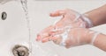 Hygiene concept. Washing hands with soap in bathroom.