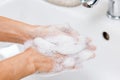 Hygiene concept. Washing hands with soap under the faucet with water Royalty Free Stock Photo