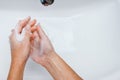 Hygiene concept. Washing hands with soap under the faucet with water Royalty Free Stock Photo