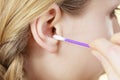 Woman cleaning ear with cotton swabs closeup Royalty Free Stock Photo