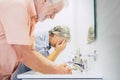 Hygiene and disinfect corona virus at home washing and cleaning hands together - old people use water in the bathroom for health Royalty Free Stock Photo
