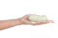 Hygiene and health care topic: a woman's hand holding a green bar of soap isolated on white background in studio Royalty Free Stock Photo