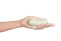 Hygiene and health care topic: a woman's hand holding a green bar of soap isolated on white background in studio Royalty Free Stock Photo