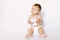 Hygiene - little baby girl get wet wipes, and wipes her face  on white background. Cleaning wipe, pure, clean Royalty Free Stock Photo