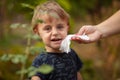 Cleaning smiling baby face and skin with wet wipes Royalty Free Stock Photo