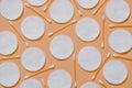 Hygiene products: round white cotton pads and cotton swabs are on colored background