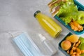 Hygiene and protection against bacteria and viruses. Delicious school lunch. Lunch box with a sandwich, fresh vegetables and Royalty Free Stock Photo