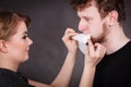 Woman wipe man face by hygienic tissue.