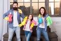 Hygiene. We will make your world spotless. Family clean house. Happy family hold cleaning products. Mother, father and Royalty Free Stock Photo