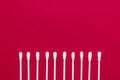 Hygienic, cotton buds on a red background. The concept of hygiene, cleanliness