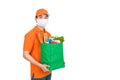 Delivery man wearing medical mask holding grocery shopping bag in supermarket Royalty Free Stock Photo