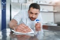 Hygienic precautions. Worker in restaurant kitchen cleaning down after service. Selective focus on his hand Royalty Free Stock Photo