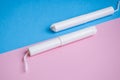 Hygienic tampons on a blue and pink background. copy space, Menstruation sanitary tampon for woman hygiene protection. Critical Royalty Free Stock Photo