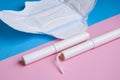 Hygienic tampons and pad on a blue and pink background. copy space Royalty Free Stock Photo