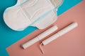 Hygienic tampons and pad on a blue and pink background. copy space Royalty Free Stock Photo