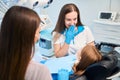 Hygienist and an assistant are conducting appointment in dental office