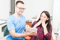 Hygienist with patient showing something on tablet