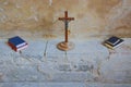 Iconic wooden crucifix with bible & hymn books Royalty Free Stock Photo