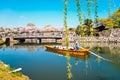 Old boat on the canal with spring cherry blossoms at Himeji Castle in Hyogo, Japan