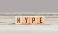 Hype word on wood cube dices on aged table