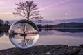 A hyperdetailed image of a glass sphere, inside of which is a tranquil lake, in whose center is a small island on which grows a Royalty Free Stock Photo
