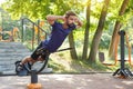 Hyperextension exercise. Fit man training on the hyperextension bench at the city park. Royalty Free Stock Photo