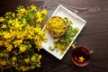 Hypericum perforatum plant flowers buds with herbal drink on wooden table, falt lay Royalty Free Stock Photo