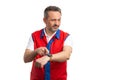 Hypermarket employee pointing at wristwatch as careful concept