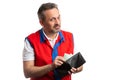 Hypermarket employee putting money inside wallet