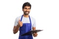 Hypermarket manager with thumb up holding clipboard Royalty Free Stock Photo