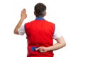 Hypermarket worker making oath with crossed fingers behind back Royalty Free Stock Photo