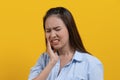 Hypersensitive teeth and gum health. young woman touching her cheek and have a dental problem