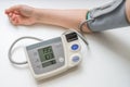 Hypertension concept. Man is measuring blood pressure with monitor Royalty Free Stock Photo