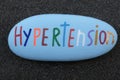 Hypertension disease word carved and painted on a stone