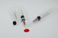 Hypodermic syringe and red drop Royalty Free Stock Photo