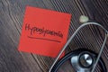Hypoglycaemia write on sticky notes isolated on Wooden Table Royalty Free Stock Photo