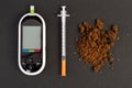 Hypoglycemia concept with glaucometer insulin syringe and brown Royalty Free Stock Photo