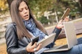 Hysterical girl with too many screens, mobils, tablets and laptops