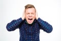 Hysterical mad young man closed ears with hands and screaming Royalty Free Stock Photo