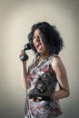Hysterical woman screaming on the phone Royalty Free Stock Photo